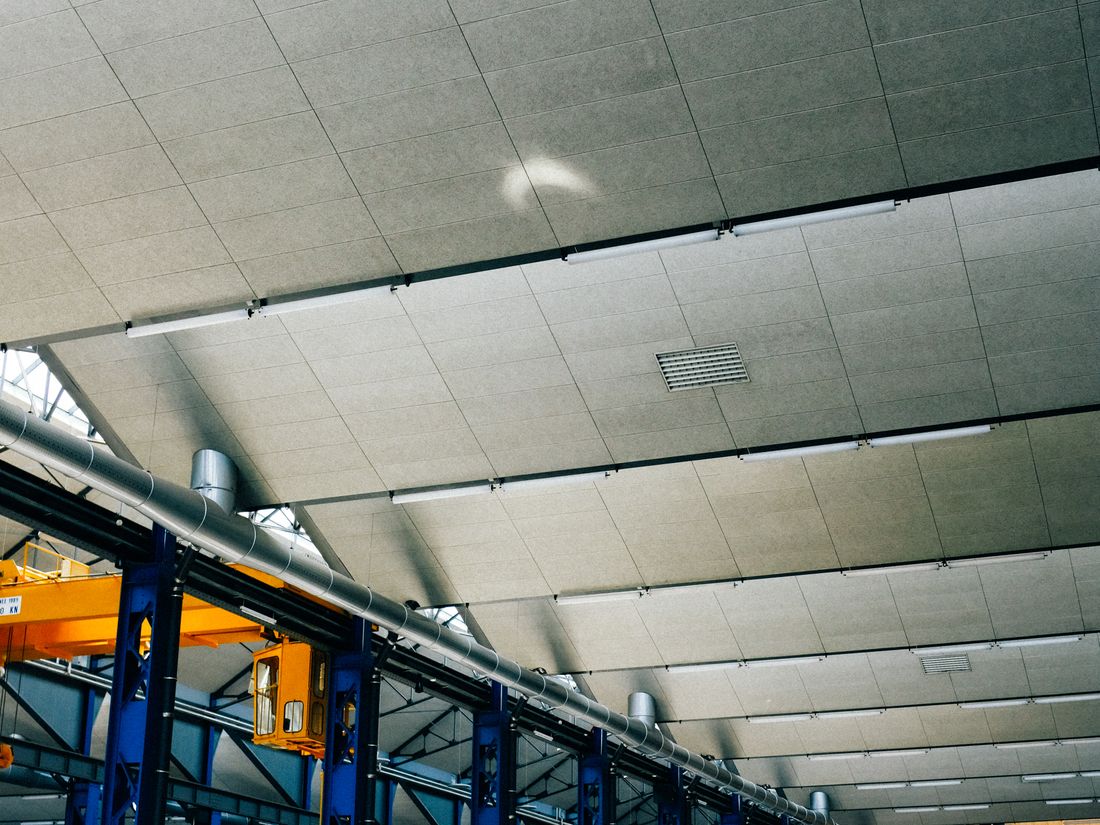 Large industrial hall with painted steel structure and polished floor