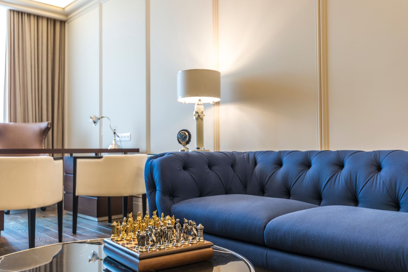 Panelled cream interior wall behind a deep blue sofa