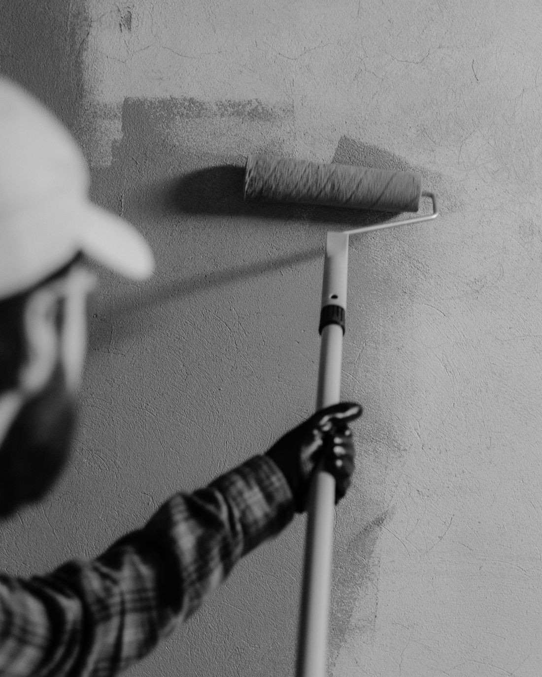 Painter rolling an even coat onto a prepared wall