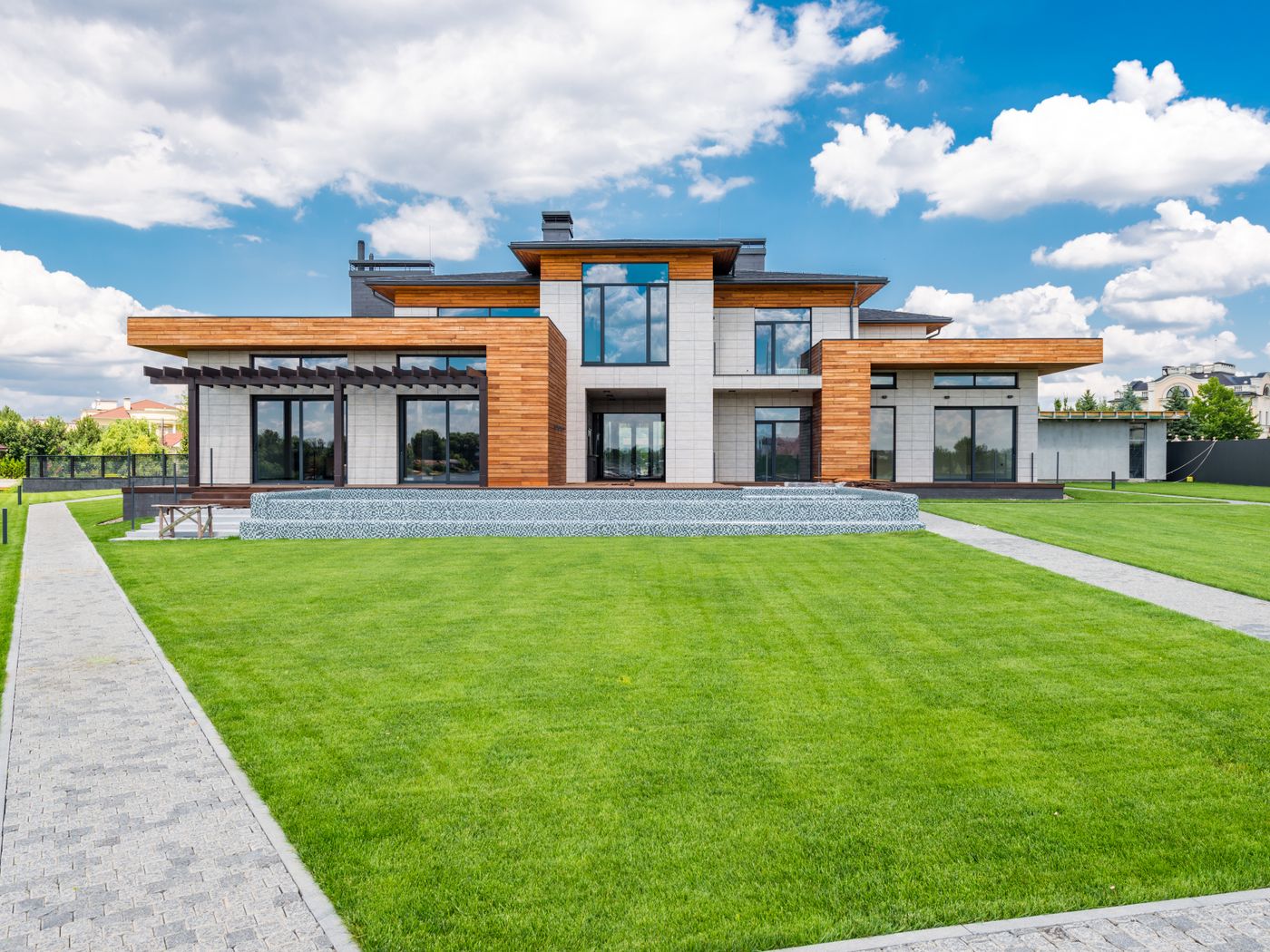 Modern home exterior with full-height glass doors and panoramic windows