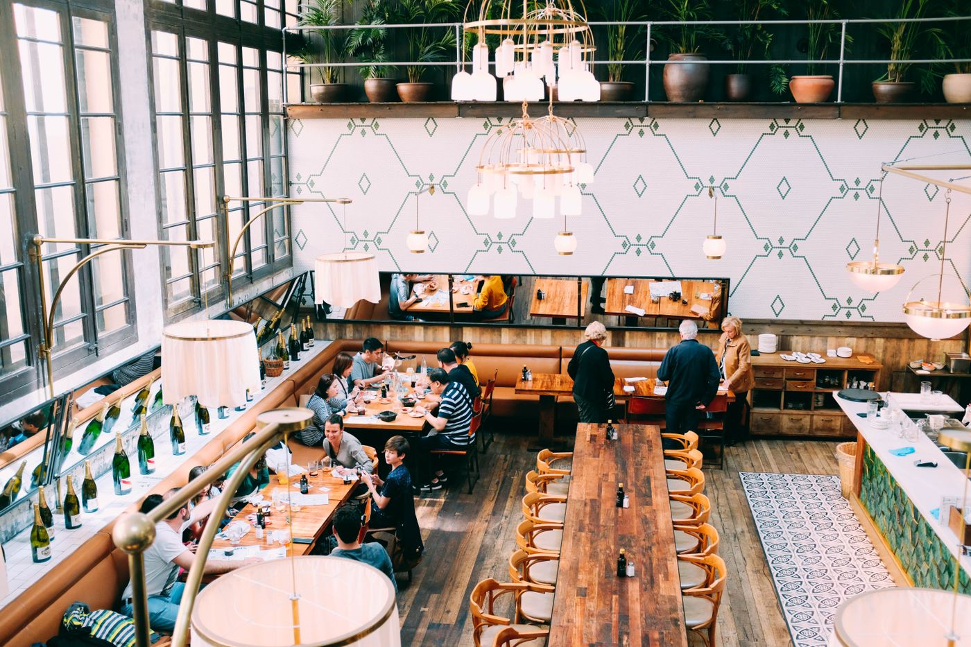 Restaurant dining room with decorative painted feature wall and timber floor